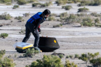 Engineer inspects OSIRIS-REx sample return capsule after touchdown in Utah