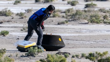 Engineer inspects OSIRIS-REx sample return capsule after touchdown in Utah